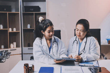 doctors and nurse having informal meeting in hospital canteenの写真素材