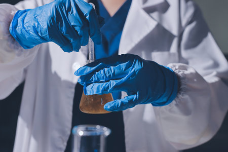 Scientist pipetting medical samples into microplate in laboratoryの写真素材