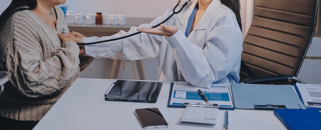 Doctor use stethoscope examining respiratory system and consultations for the elderly patients, talking check-up health or sharing test resultsの写真素材