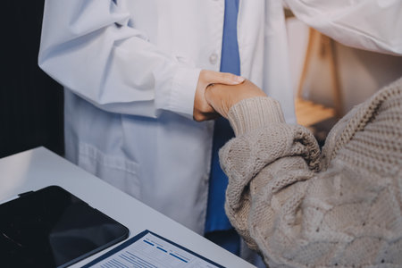 Doctor hand reassuring her female patientの写真素材