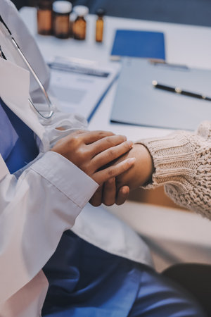 Medicine doctor hand reassuring her female patientの写真素材