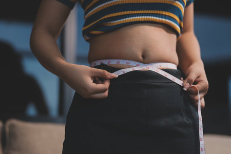 Cropped shot of woman touching her belly.の写真素材