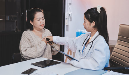 Doctor examining patients and consultations for the elderly, talking check-up health or sharing test resultsの写真素材