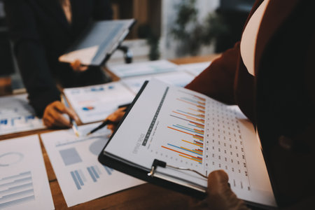 Group of business people brainstorming in analytical plan meeting Calculate the numbers obtained from the graph. Financial growth chart. Marketing. Concept of business success statistics.の写真素材