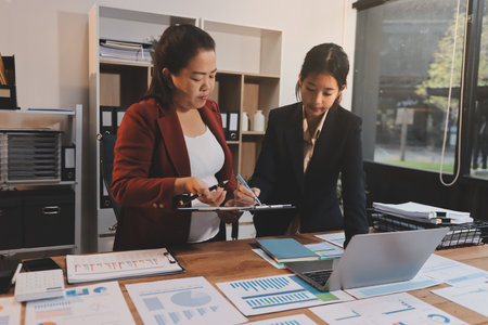 Business meeting time. Business man and business woman working on startup project.の写真素材