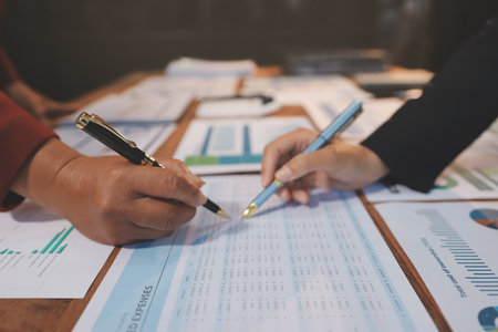 Group of business people brainstorming in analytical plan meeting Calculate the numbers obtained from the graph. Financial growth chart. Marketing. Concept of business success statistics.の写真素材