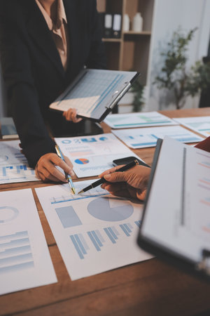 Group of business people brainstorming in analytical plan meeting Calculate the numbers obtained from the graph. Financial growth chart. Marketing. Concept of business success statistics.の写真素材