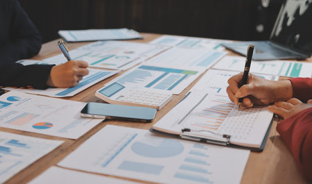 Group of business people brainstorming in analytical plan meeting Calculate the numbers obtained...