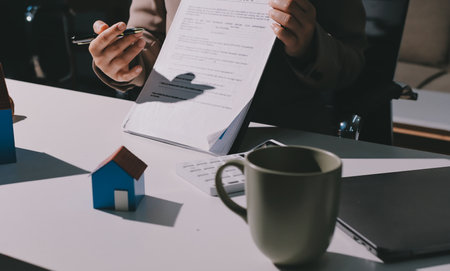 Female Real Estate Broker presenting and advised to 
model home and building project detail in the office, sign purchase sales contract, agreements concerned mortgage loan offer and insurance.の写真素材