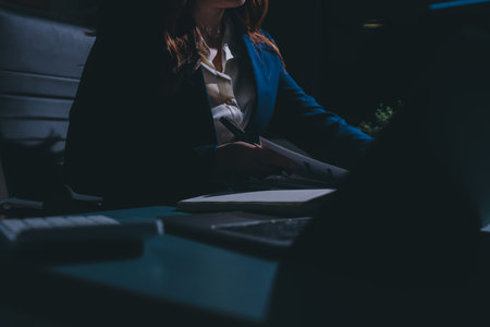 Expert woman asian female people review data number costing managerial account prepare monthly actual cost variance report at tax audit office. ESG sheet budget control ERP process service project.の写真素材
