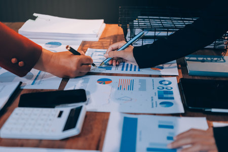 Group of business people brainstorming in analytical plan meeting Calculate the numbers obtained from the graph. Financial growth chart. Marketing. Concept of business success statistics.の写真素材