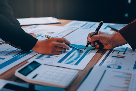 Group of business people brainstorming in analytical plan meeting Calculate the numbers obtained from the graph. Financial growth chart. Marketing. Concept of business success statistics.の写真素材