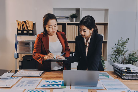 Business meeting time. Business man and business woman working on startup project.の写真素材