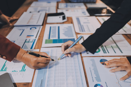 Group of business people brainstorming in analytical plan meeting Calculate the numbers obtained from the graph. Financial growth chart. Marketing. Concept of business success statistics.の写真素材