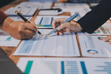 Group of business people brainstorming in analytical plan meeting Calculate the numbers obtained from the graph. Financial growth chart. Marketing. Concept of business success statistics.の写真素材