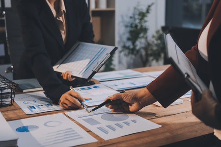 Group of business people brainstorming in analytical plan meeting Calculate the numbers obtained from the graph. Financial growth chart. Marketing. Concept of business success statistics.の写真素材