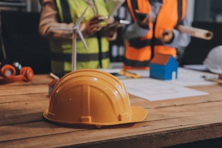 Engineers are helping to design work on blueprints and collaborate on structural analyzing of project types.の写真素材