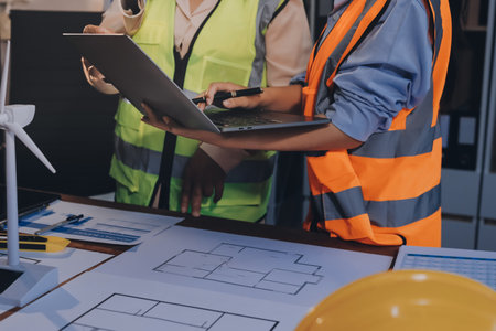 Engineers are helping to design work on blueprints and collaborate on structural analyzing of...