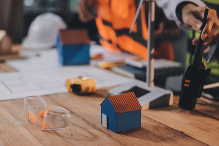 Engineers are helping to design work on blueprints and collaborate on structural analyzing of...
