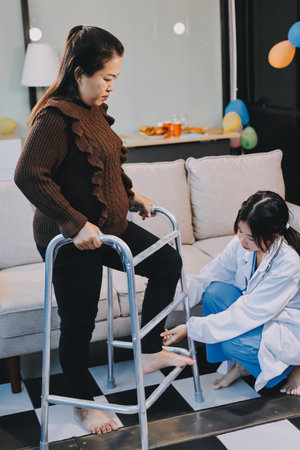 Young doctor examines senior patient's legの写真素材