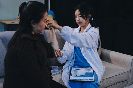 Orthopaedic doctor doing physical examination patient with wrist pain at the clinic. Physical...
