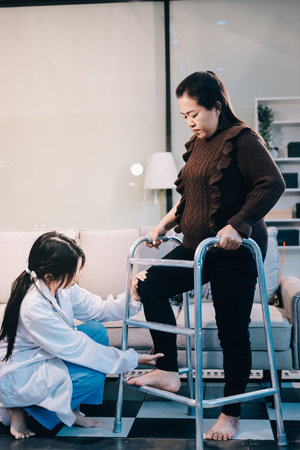 Young doctor examines senior patient's legの写真素材