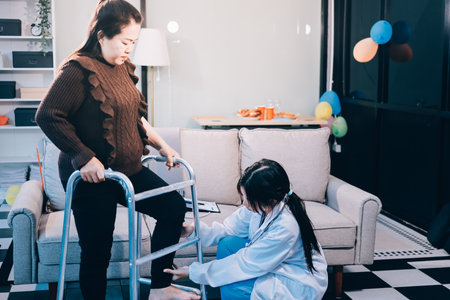 Young doctor examines senior patient's legの写真素材