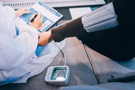 Doctor using Blood pressure monitor and stethoscope checking measuring arterial blood pressure on...