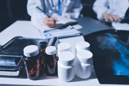 Male and female doctors are having a meeting in a hospital room.の写真素材