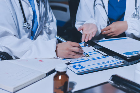 Male and female doctors are having a meeting in a hospital room.の写真素材