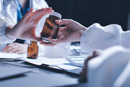 Male and female doctors are having a meeting in a hospital room.の写真素材