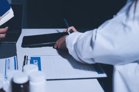 Male and female doctors are having a meeting in a hospital room.の写真素材