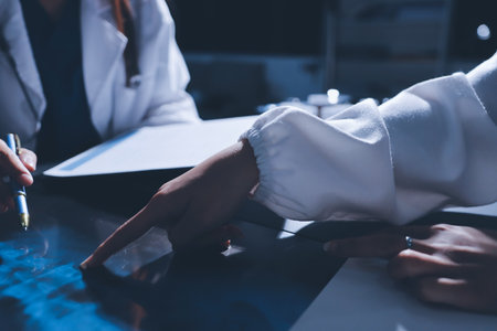 Male and female doctors are having a meeting in a hospital room.の写真素材