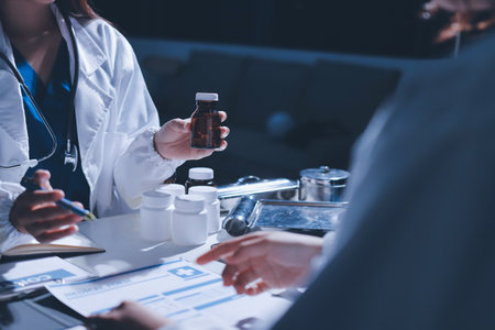Male and female doctors are having a meeting in a hospital room.の写真素材