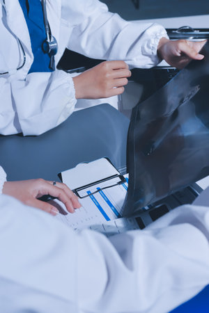 Male and female doctors are having a meeting in a hospital room.の写真素材