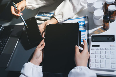 Male and female doctors are having a meeting in a hospital room.の写真素材