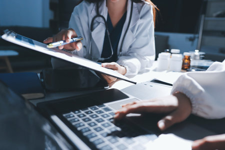 Male and female doctors are having a meeting in a hospital room.の写真素材
