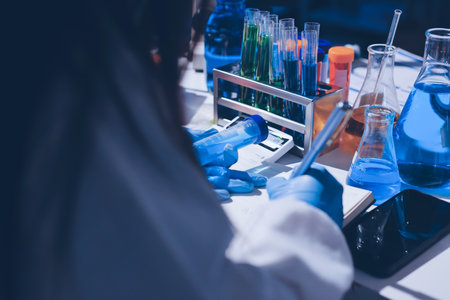 Scientist pipetting medical samples into microplate in laboratoryの写真素材