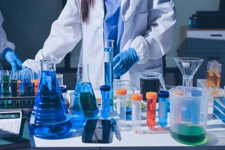 Scientist pipetting medical samples into microplate in laboratoryの写真素材