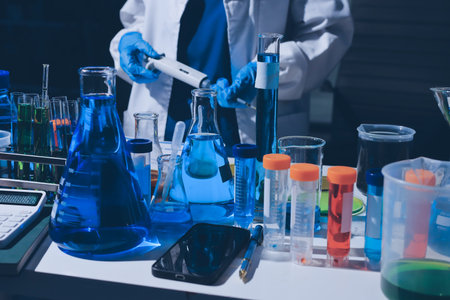 Scientist pipetting medical samples into microplate in laboratoryの写真素材