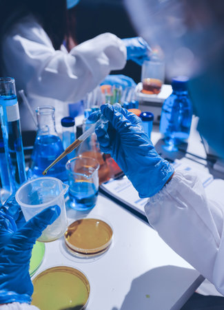 Scientist pipetting medical samples into microplate in laboratoryの写真素材