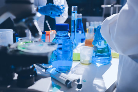 Scientist pipetting medical samples into microplate in laboratoryの写真素材