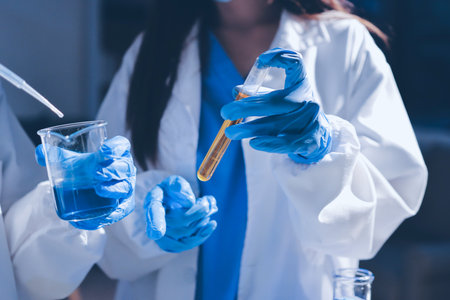 Scientist pipetting medical samples into microplate in laboratoryの写真素材