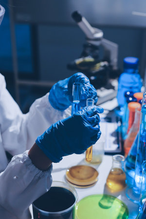 Scientist pipetting medical samples into microplate in laboratoryの写真素材
