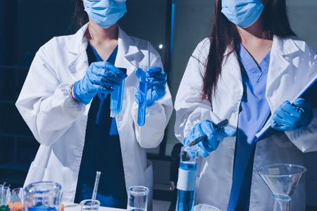 Scientist pipetting medical samples into microplate in laboratoryの写真素材