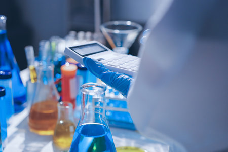 Scientist pipetting medical samples into microplate in laboratoryの写真素材