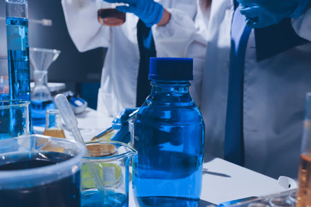 Scientist pipetting medical samples into microplate in laboratoryの写真素材