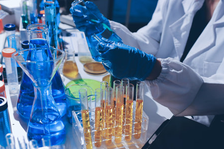 Scientist pipetting medical samples into microplate in laboratoryの写真素材
