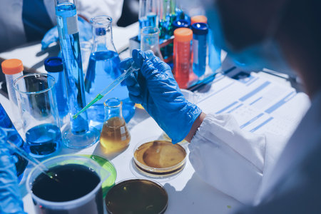 Scientist pipetting medical samples into microplate in laboratoryの写真素材