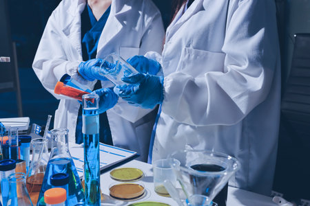 Scientist pipetting medical samples into microplate in laboratory
